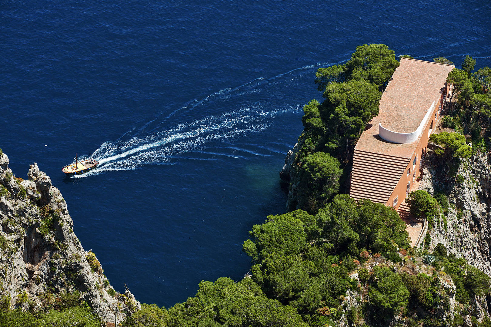 Looking out at a boat passing by the cliffs near Capri island