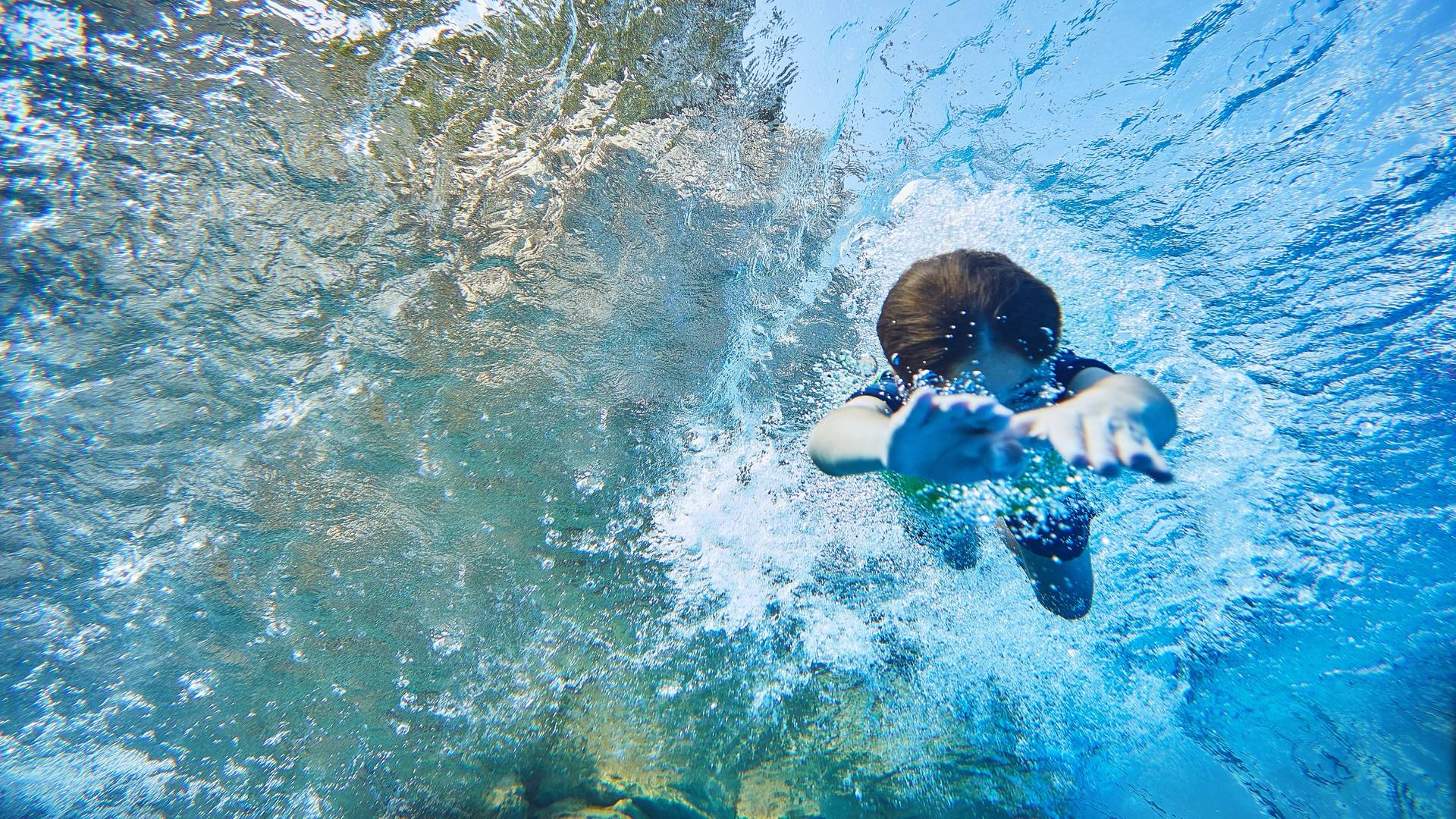A child diving beneath the water