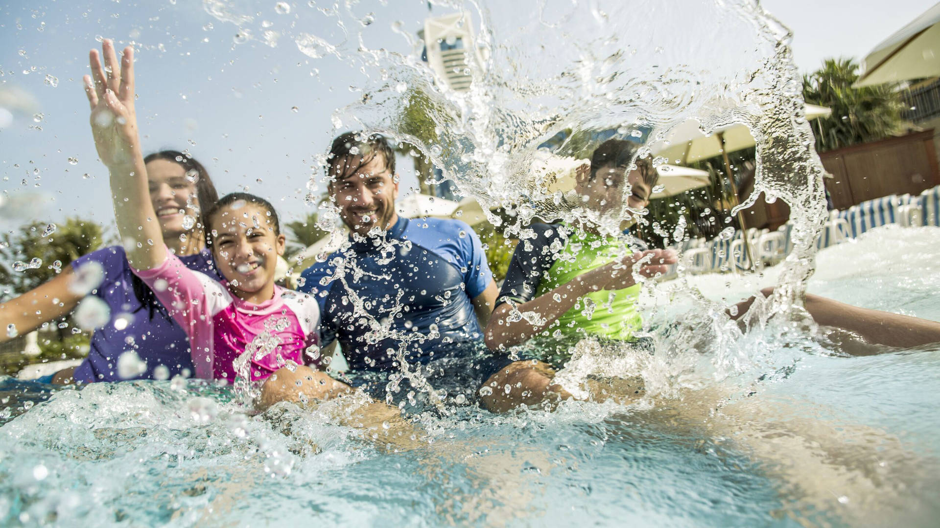 A family splashing in the Wild Wadi slide