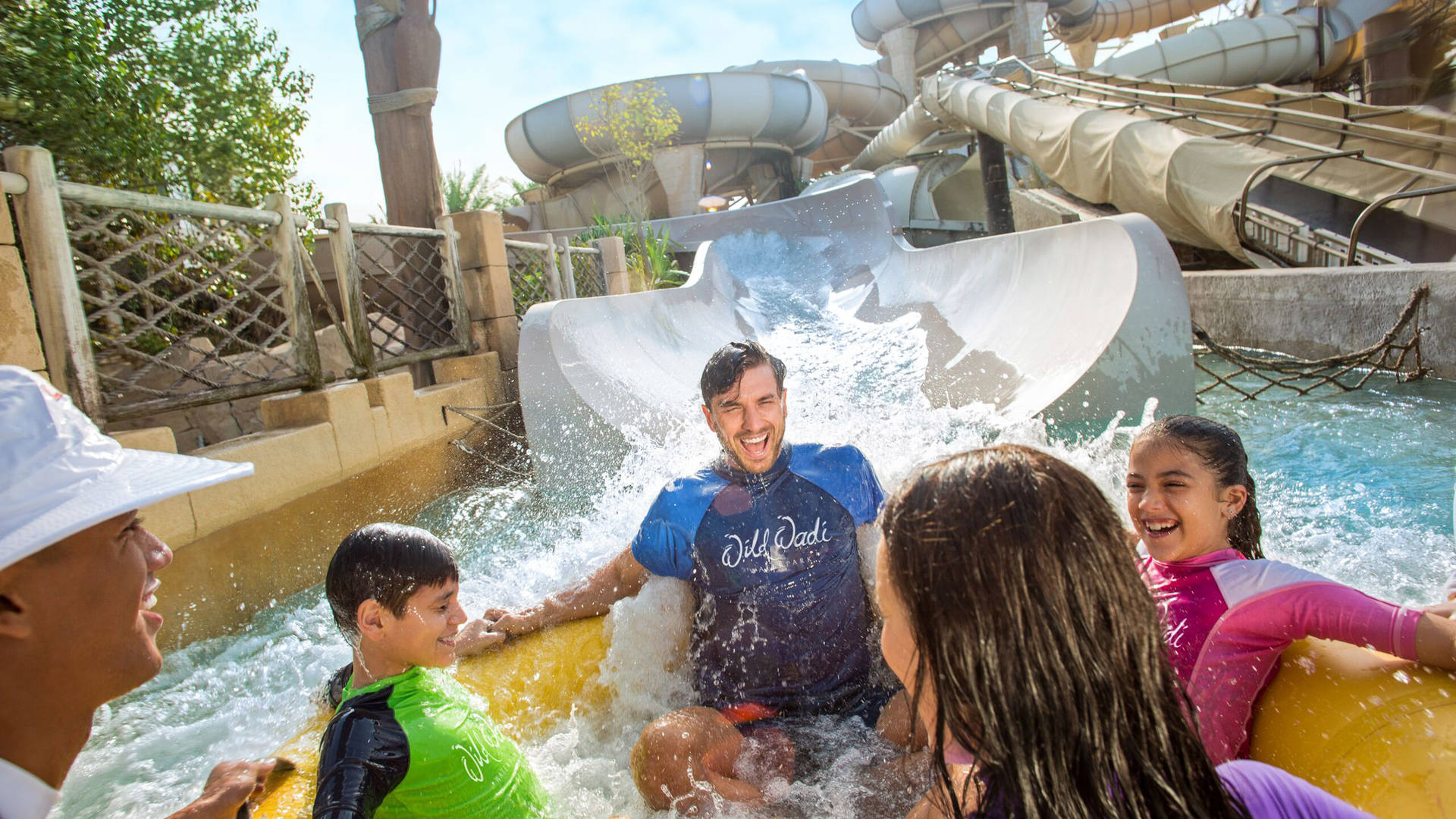 Family having fun on a rubber ring in Wild Wadi