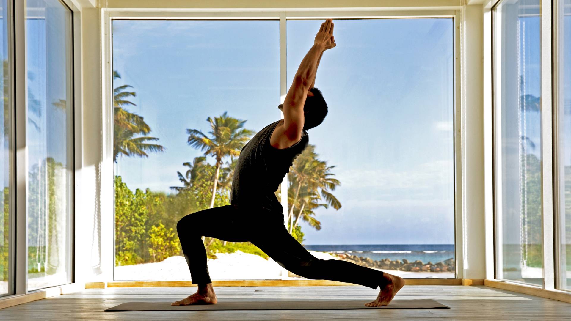 A man doing yoga at Jumeirah Maldives